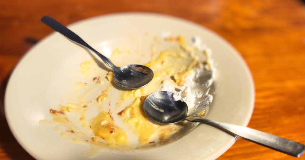 GATOR SHACK RESTAURANT THIS IS AN IMAGE OF AN EMPTY DESSERT BOWL WITH TWO SPOONS