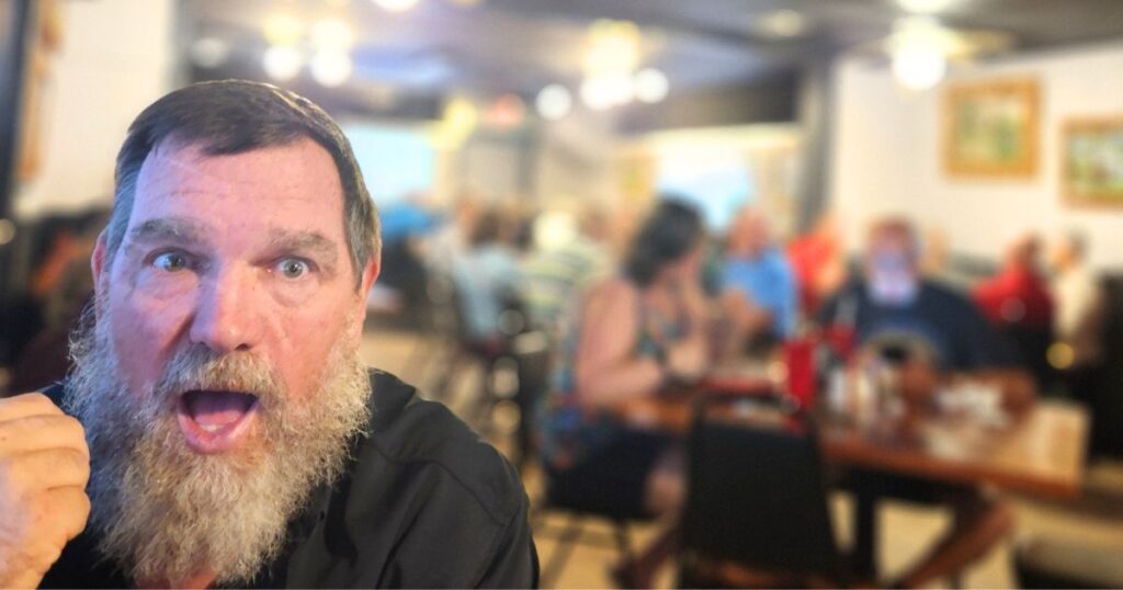 THIS IS AN IMAGE OF A MAN HAVING FUN AT THE GATOR SHACK