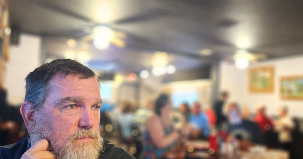 THIS IS AN IMAGE OF A MAN AT THE GATOR SHACK