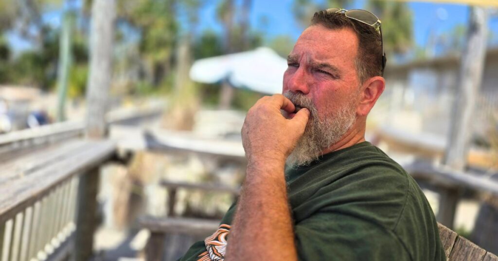 TOMOKA STATE PARK THIS IS AN IMAGE OF A MAN EATING BOILED PEANUTS AT TOMOKA OUTPOST