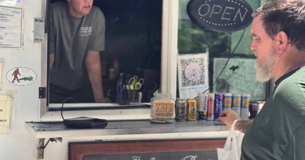 THIS IS AN IMAGE OF A MAN AT THE MYAKKA RIVER STATE PARK FOOD TRUCK