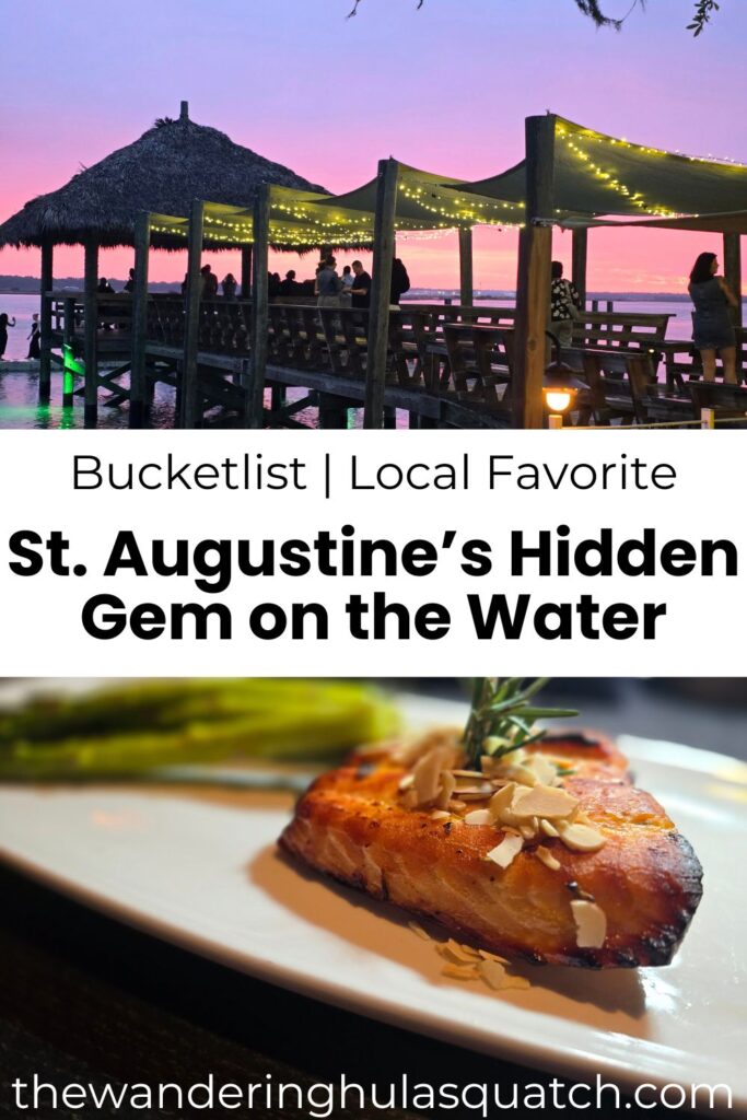 PINTEREST graphic for a travel blog post titled 'St. Augustine’s Hidden Gem on the Water.' The top half features a scenic sunset view of a tiki-style pier restaurant lit with string lights and people enjoying the evening. The bottom half shows a close-up of a perfectly seared piece of fish topped with slivered almonds and garnished with herbs, served with asparagus. Text overlay reads: 'Bucketlist | Local Favorite – St. Augustine’s Hidden Gem on the Water' with thewanderinghulasquatchcom.bigscoots-staging.com at the bottom.