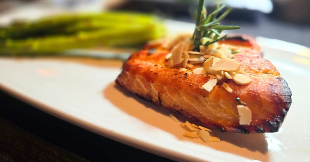 ST. AUGUSTINE HIDDEN GEM RESTAURANT WITH A VIEW IMAGE OF SALMON ON A PLATE WITH ASPARAGUS
