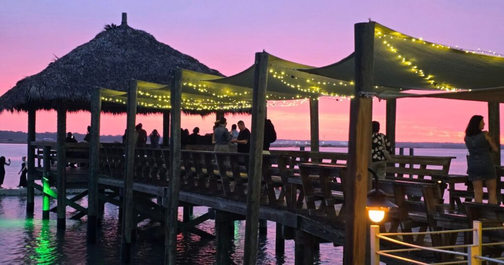 ST. AUGUSTINE HIDDEN GEM RESTAURANT WITH A VIEW IMAGE OF SUNSET ON THE DOCK AT CAPS ON THE WATER