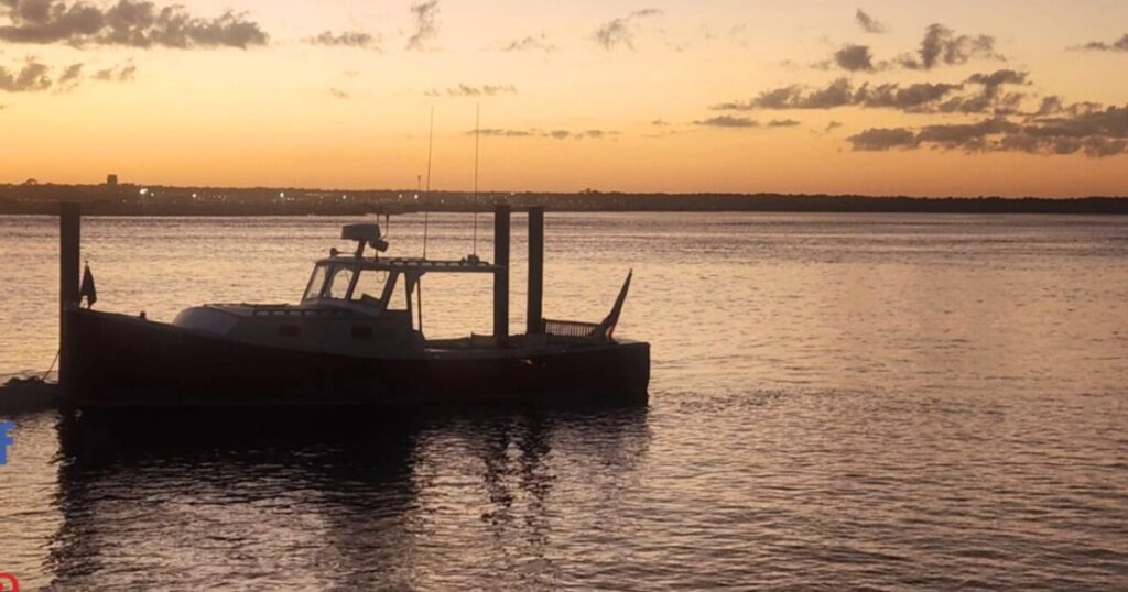Sunset view over the water in St. Augustine with a boat docked in the foreground, capturing the peaceful waterfront ambiance near a hidden gem restaurant.