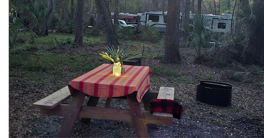 THE BEST CAR CAMPING PORTABLE KITCHEN AND SETUP THIS IS AN IMAGE OF A CAMP LIGHT ON ON A PICNIC TABLE