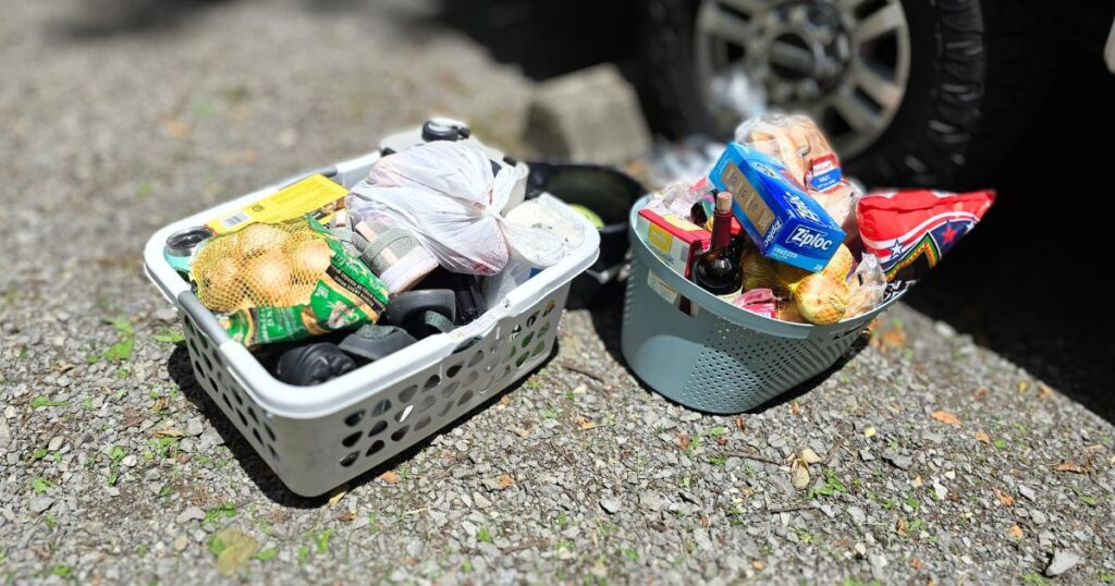THIS IS AN IMAGE OF USING LAUNDRY BASKETS FOR CAMPING FOOD DTORAGE
