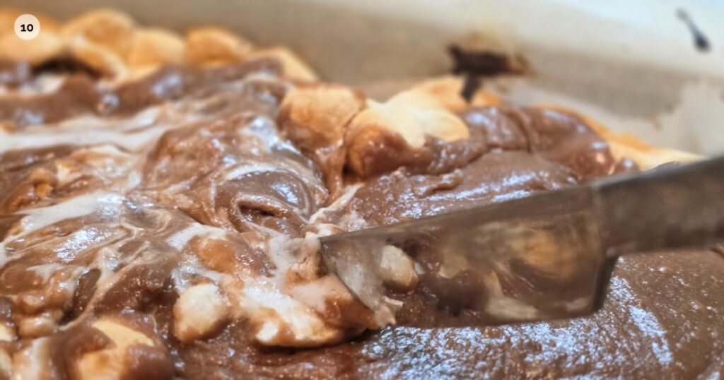 GOOEY S'MORES BAR RECIPE THIS IS AN IMAGE SWIRLING THE FROSTING AND MARSHMALLOWS TOGETHER