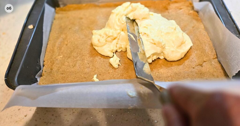 GOOEY S'MORES BAR RECIPE THIS IS AN IMAGE SPREADING THE FILLING LAYER ON THE GRAHAM CRUST LAYER