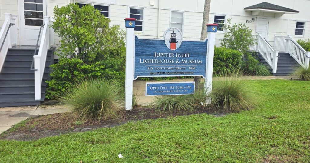 Jupiter Inlet Lighthouse and Museum sign at the historic lighthouse location in Florida, open Tu-Sun 10am-5pm.