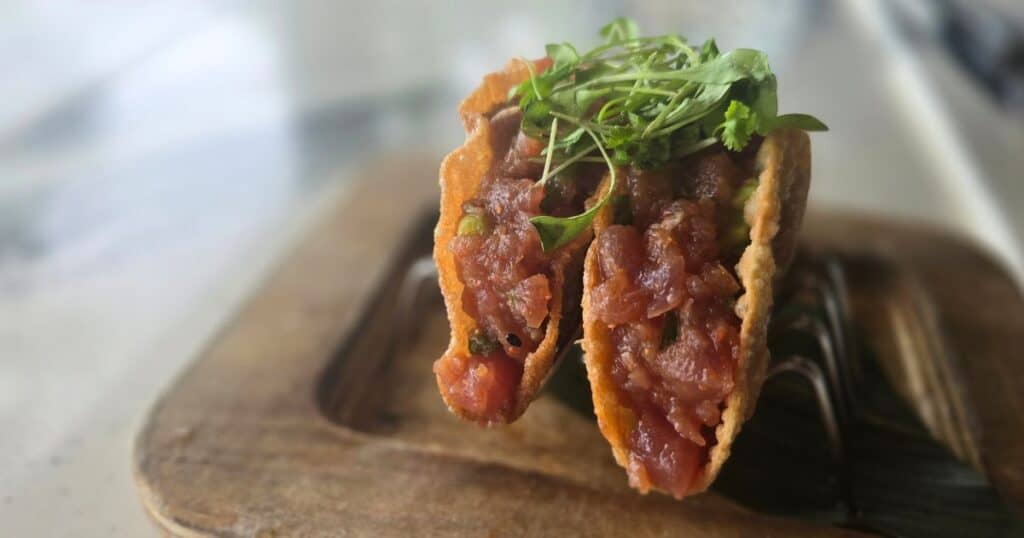Savory meat-filled taco with fresh cilantro and crispy shell, perfect for Hawaiian street food lovers.