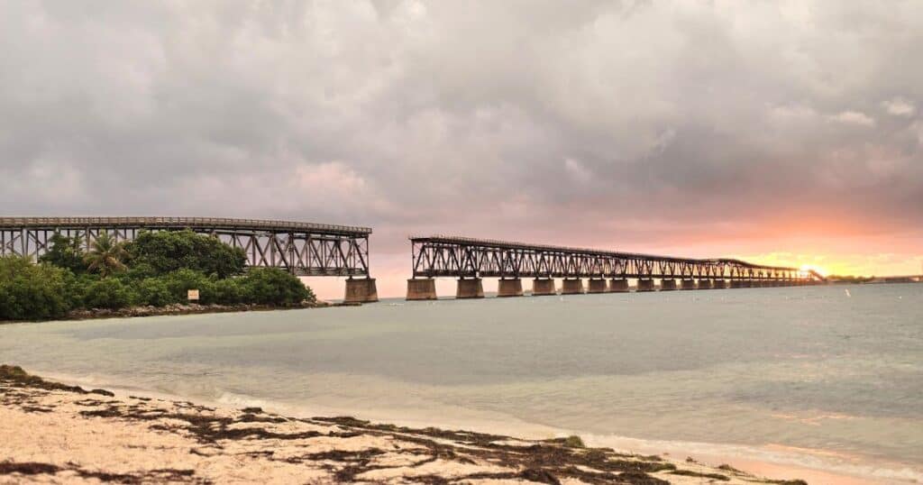 Old Railroad Bridge over Ocean at Sunset, Scenic Coastal View, Nature and Travel Photography.