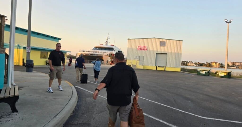 Boulder Harbor ferry terminal with travelers heading to San Diego, boats docked, and waterfront waiting area.