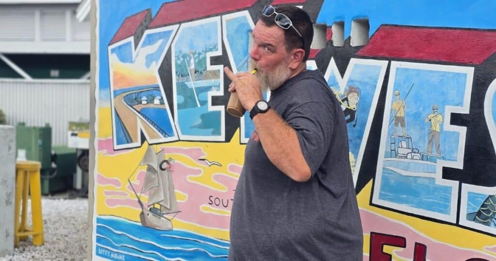 Kayaking mural artwork on vibrant colorful wall at The Wandering Hulasquatch, outdoor scene.