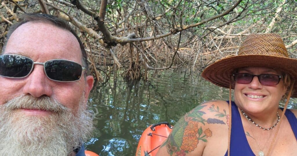 FLORIDA ADVENTURE TRAVEL COUPLE KAYAKING IN CURRY HAMMOCK'S MANGROVE TUNNELS