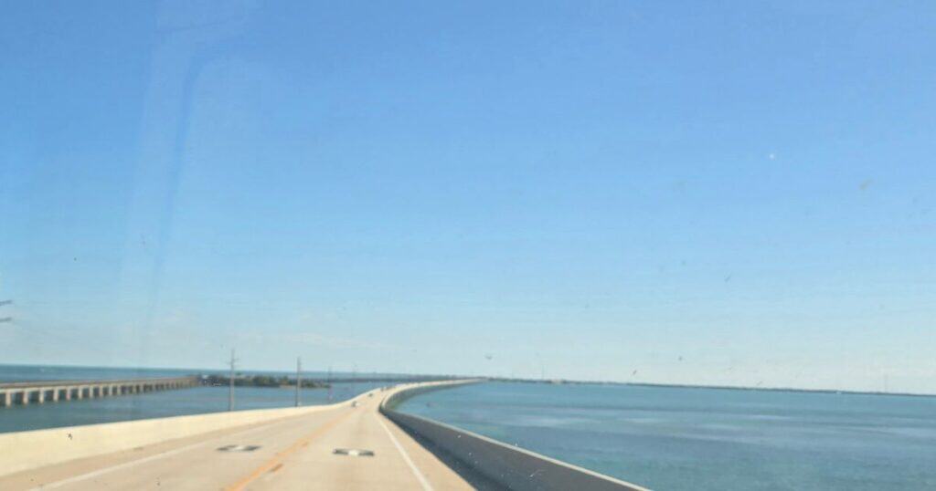 Driving on US-1 Overseas Highway over water in the Florida Keys toward Geiger Key Marina restaurant